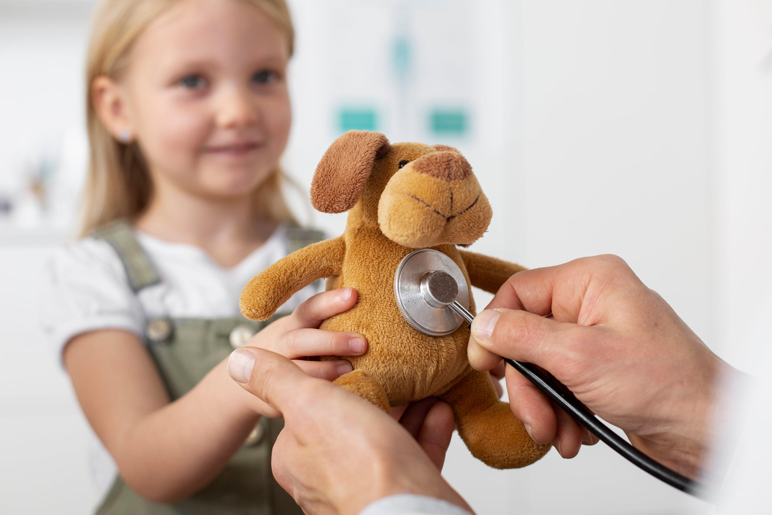 West Coast Pediatrics Clinic Girl with teddy bear at Pediatric clinic